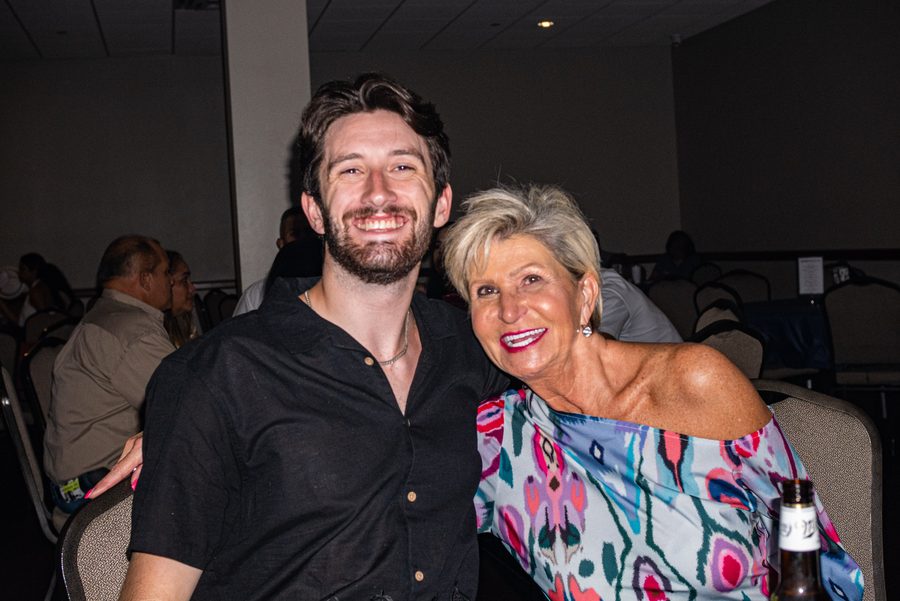 Graduate and a guest smiling together at a party